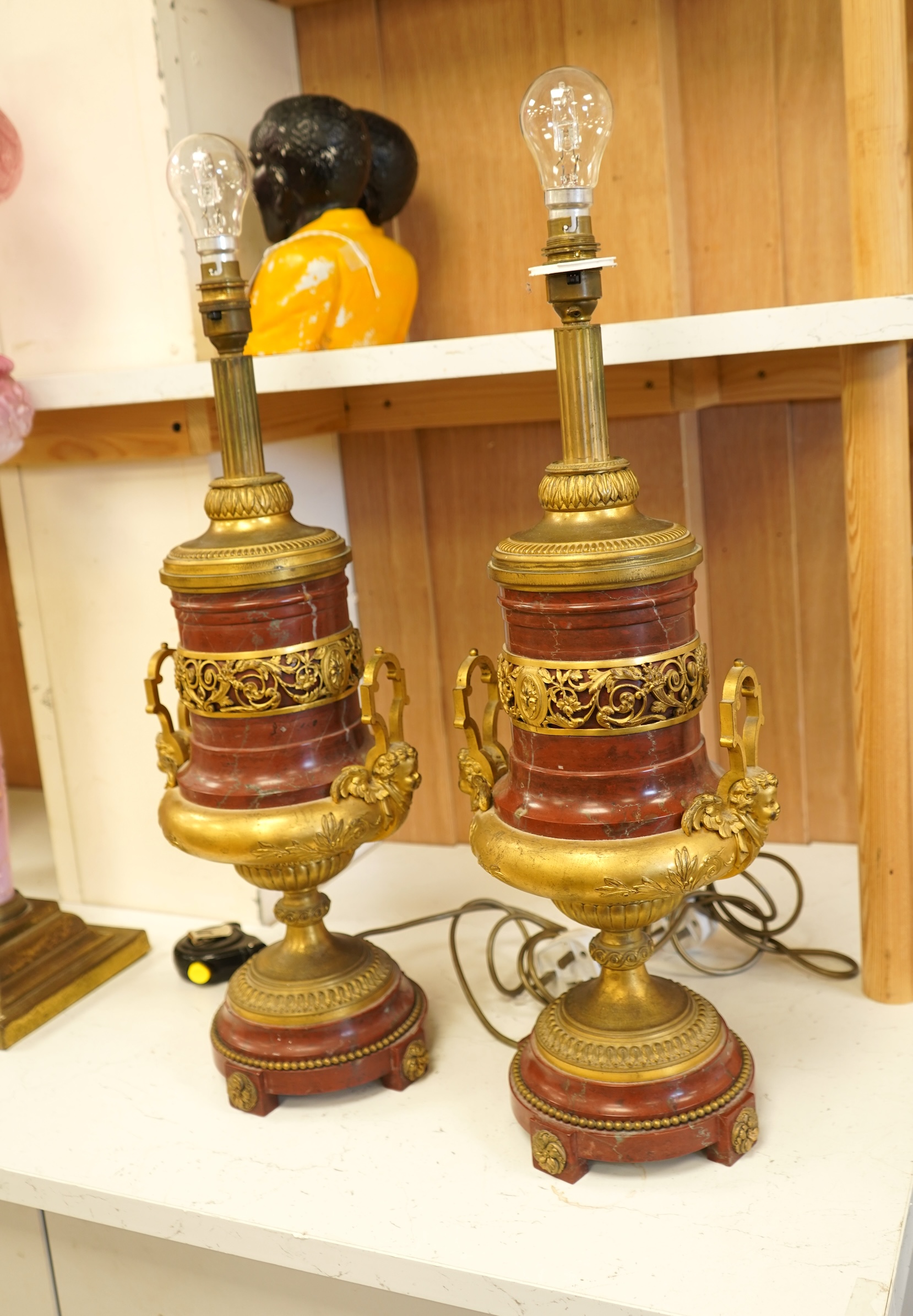 A pair of Empire style gilt metal and rouge marble table lamps, 50cm